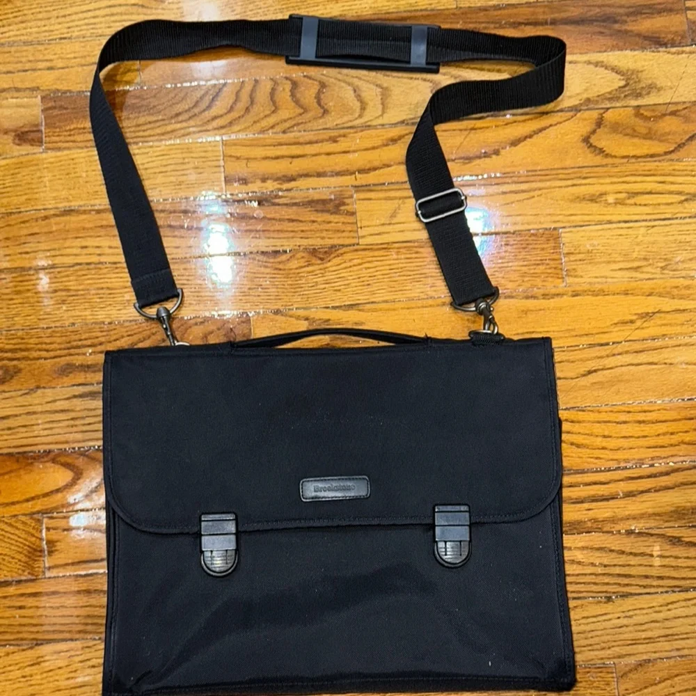 Brookstone black neoprene waterproof lap top bag with detachable shoulder strap.
